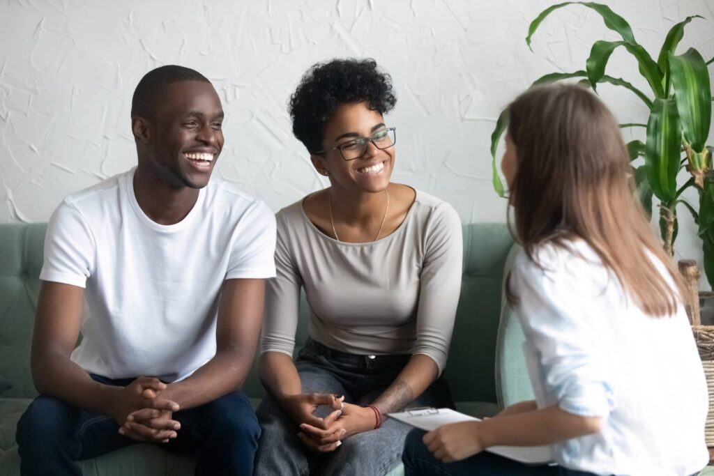 Couple smiling during a counseling session.