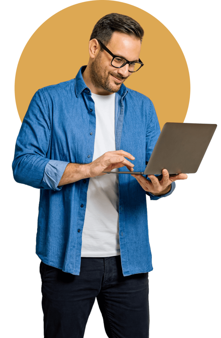 A man in a blue shirt using a laptop. A man in a blue shirt using a laptop.