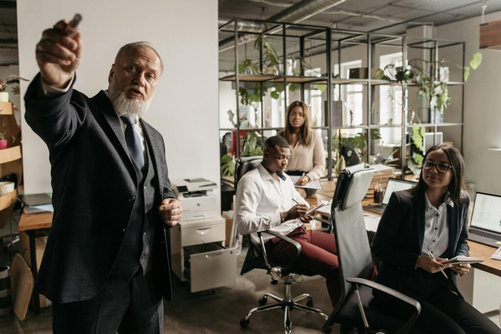 Senior executive presenting to team in office