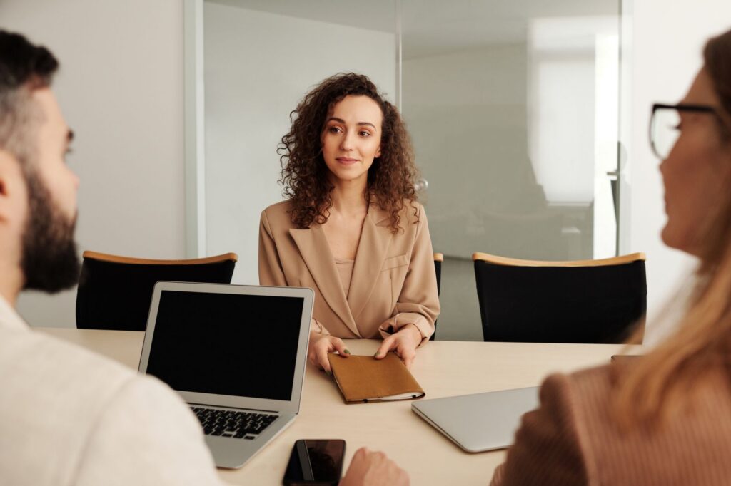 Woman handing folder in business meeting
