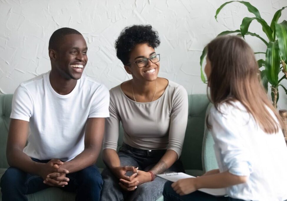 Couple smiling during a counseling session.