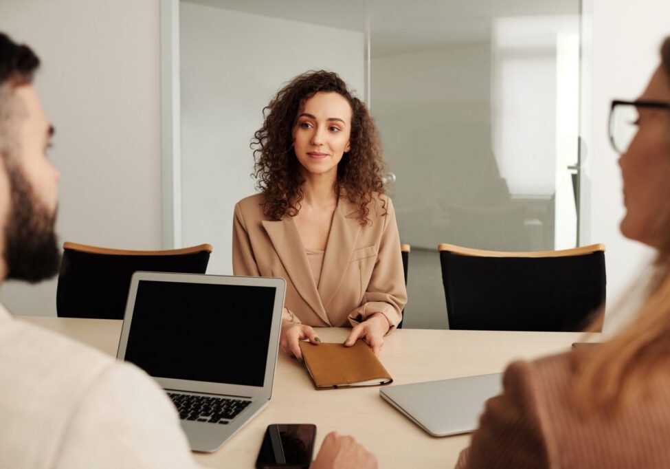 Woman handing folder in business meeting
